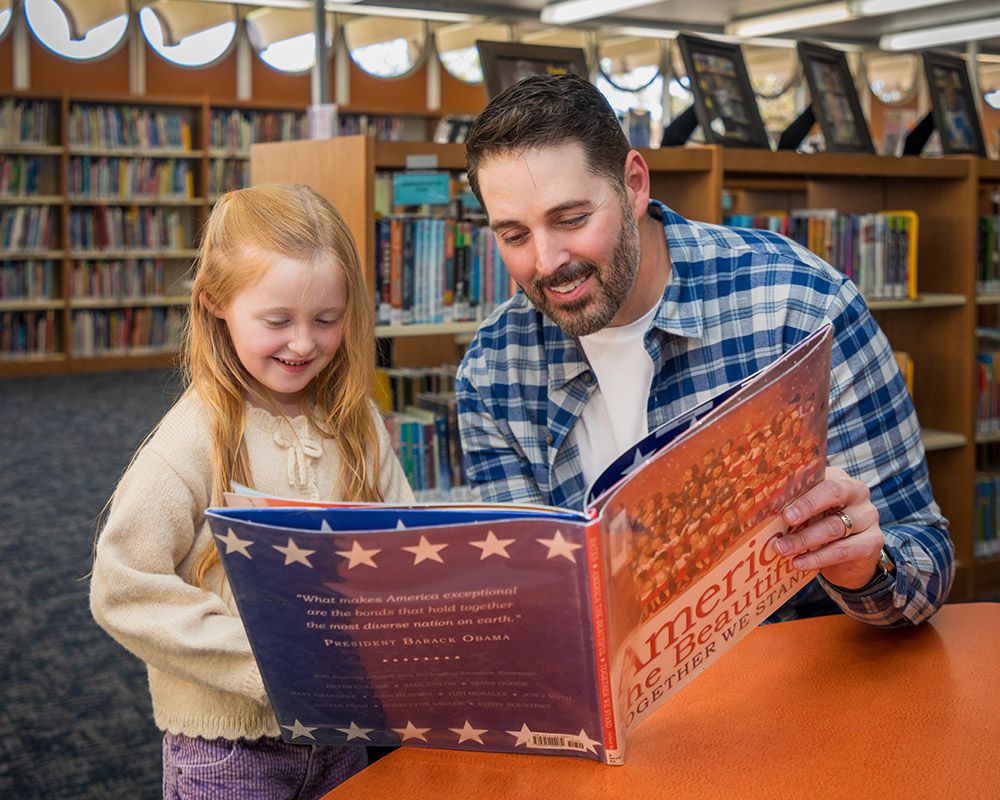 Major Kinsley Jordan reading with children